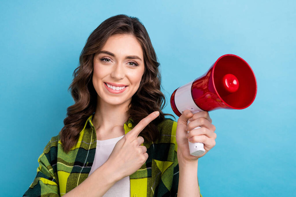 Photo of pretty cute lady wear checkered jacket pointing finger bullhorn isolated blue color background. - Foto, Imagem
