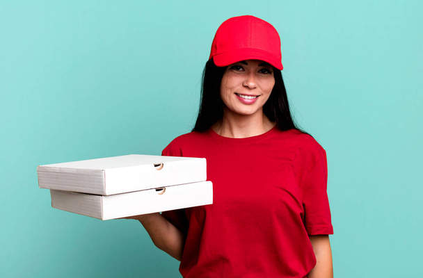 hispanic pretty woman looking happy and pleasantly surprised. delivery pizza concept - Foto, afbeelding
