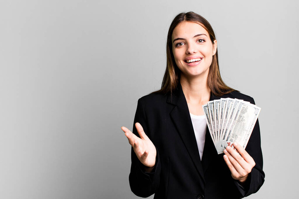 young pretty woman feeling happy, surprised realizing a solution or idea. business and dolla banknotes concept - Photo, Image