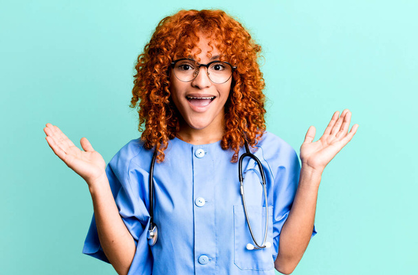 red hair pretty woman feeling happy and astonished at something unbelievable. nurse concept - 写真・画像