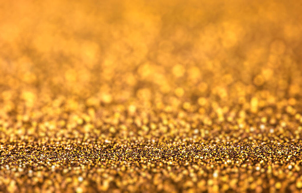 Shiny golden glitter texture background closeup. - Photo, image