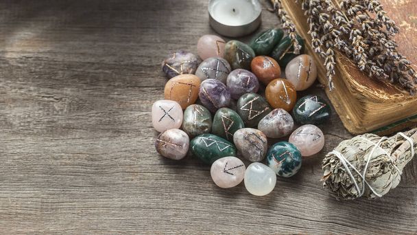 Elder Futhark Rune Stones Set Made of Natural Gemstones on Wooden Background - Фото, изображение