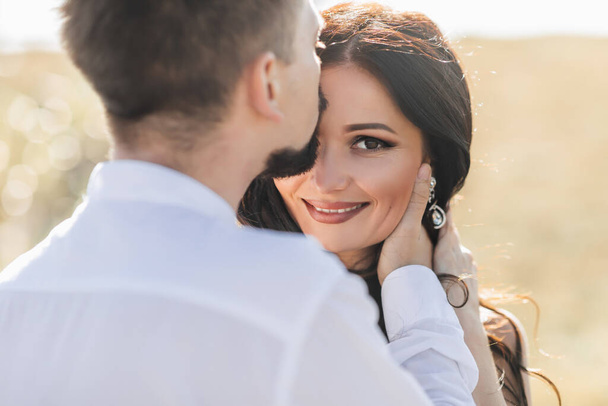 Beautiful Couple In Love. Portrait Of Handsome Man Kissing Happy Smiling Woman With Smooth Soft Silky Face Skin. Romantic Sensual Male And Affectionate Loving Female. Relationships. High Resolution - 写真・画像