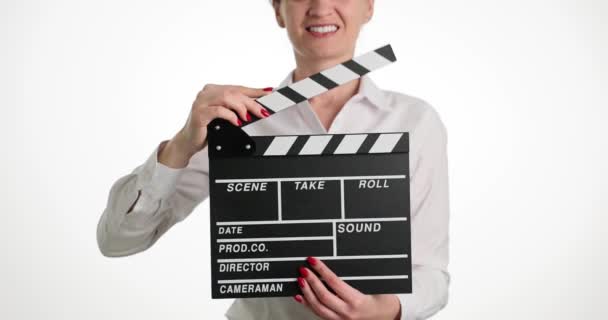 Smiling female assistant director banging clapperboard during closeup filming. Start of filming - Footage, Video