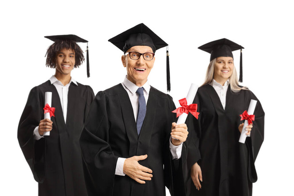 Proud graduate students and an elderly man holding certificates and smiling isolated on white background - 写真・画像