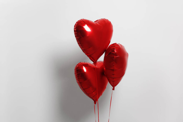 Many red heart shaped balloons on white background - Fotoğraf, Görsel