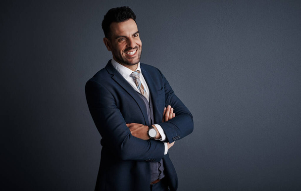 Style goes a long way towards being successful. Studio shot of a stylish and confident young businessman posing against a gray background - Φωτογραφία, εικόνα
