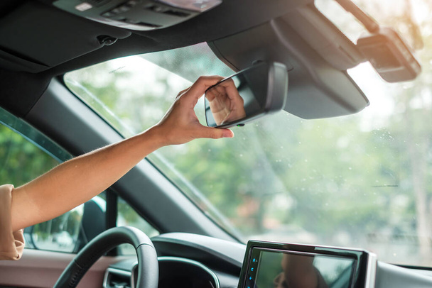 woman driver adjusting rear view mirror a car. Journey, trip and safety Transportation concepts - Φωτογραφία, εικόνα