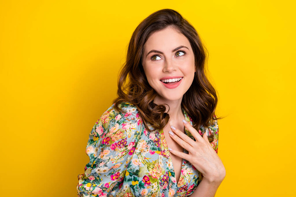 Photo of adorable excited lady wear retro flower print blouse arm chest looking empty space isolated yellow color background. - Valokuva, kuva