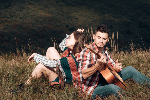 Couple in love on camp. Romantic music and happy couple relationships. Romance couple with guitar - Valokuva, kuva