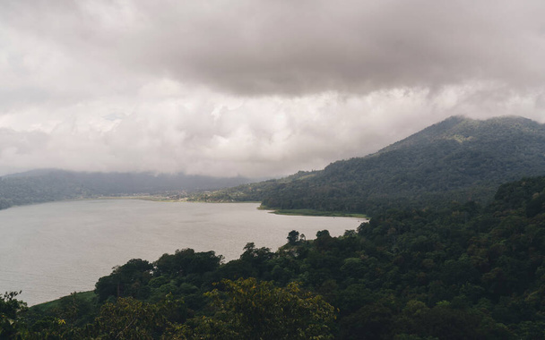 A popular attraction of the tropical island of Bali, Indonesia. Amazing scenic view from above, Lake Batur on a cloudy rainy cloudy day. - Valokuva, kuva