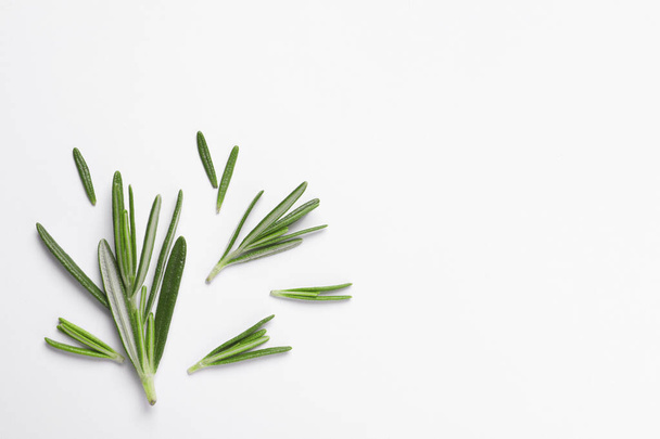 Sprigs of fresh rosemary on white background, flat lay. Space for text - Foto, Imagem