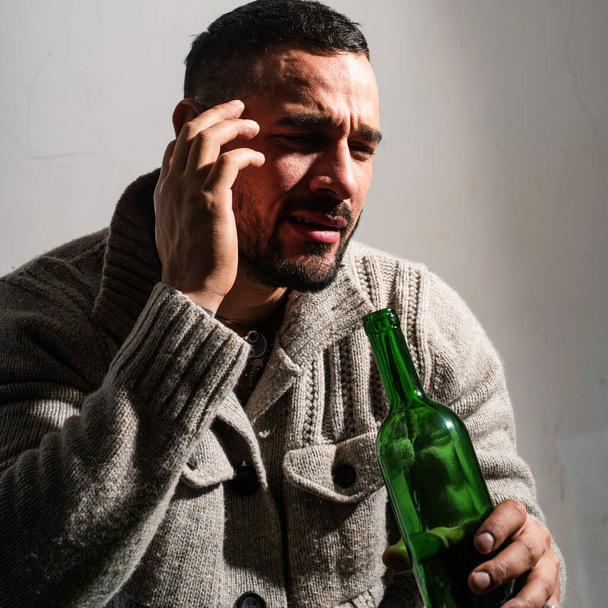 Alcoholic man with bottles wine cry. Depressed crying man. Drunk men drinking alcohol feeling lonely and desperate in emotional stress - Zdjęcie, obraz
