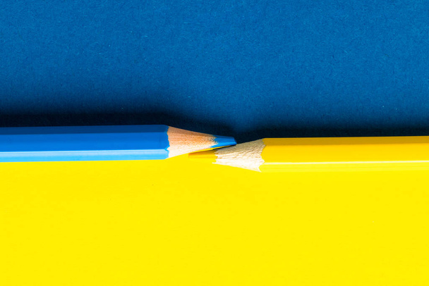 Close up of yellow and blue pencils with copy space on yellow and blue background. School materials, writing, colouring, drawing, learning, school and education concept. - Foto, Imagem