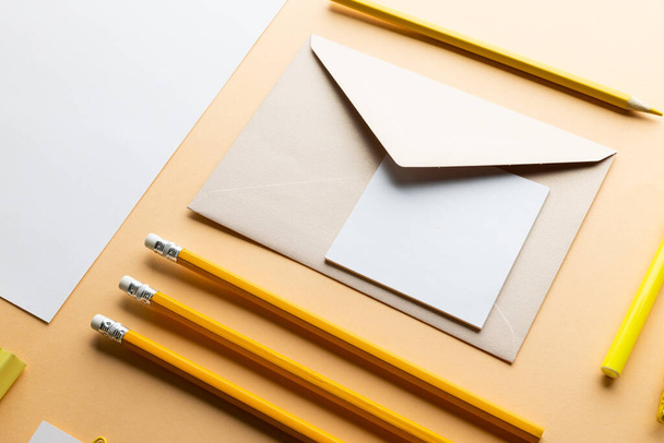 Flat lay of yellow pencils, pen and white paper with copy space on yellow background. School materials, writing, colouring, drawing, learning, school and education concept. - Fotó, kép