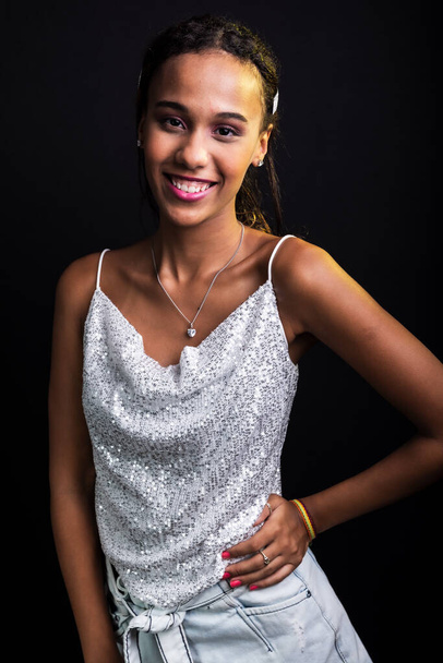 Studio portrait of teen girl, in white clothes, isolated on black background. - Fotografie, Obrázek