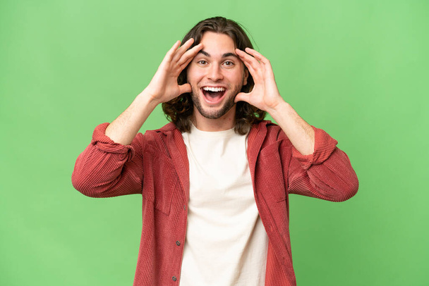 Young handsome man over isolated background with surprise expression - Photo, Image