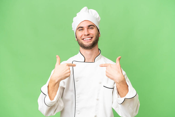 jovem bonito chef homem sobre isolado fundo orgulhoso e auto-satisfeito - Foto, Imagem