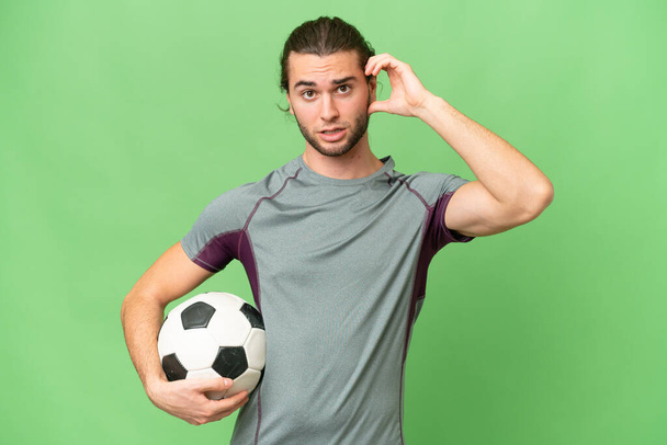 Young handsome football player man over isolated background having doubts - Zdjęcie, obraz