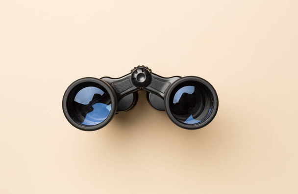 Black binoculars on color background. Top view - Photo, Image