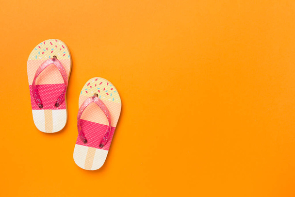 Bright flip flops on color background, top view - 写真・画像