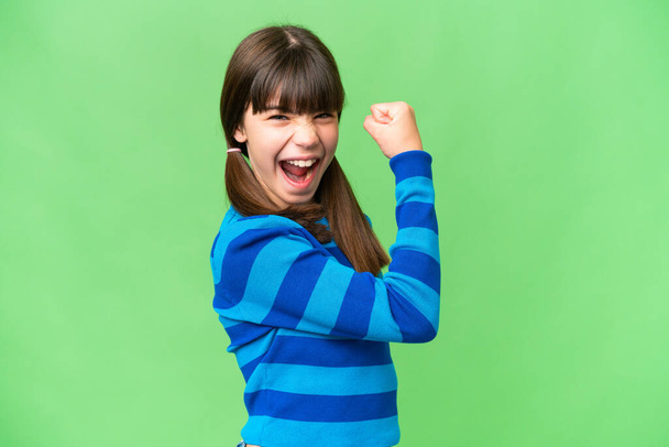 Little caucasian girl over isolated background celebrating a victory - Foto, imagen