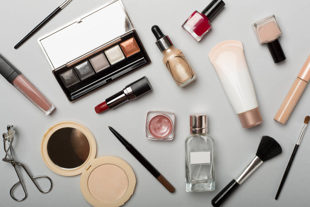 Different makeup products on color background, top view. - 写真・画像