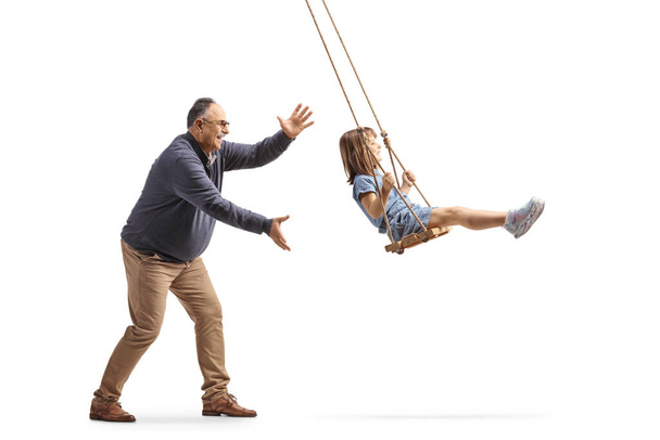 Grandad pushing a little girl on a swing isolated on white background - Foto, Imagen