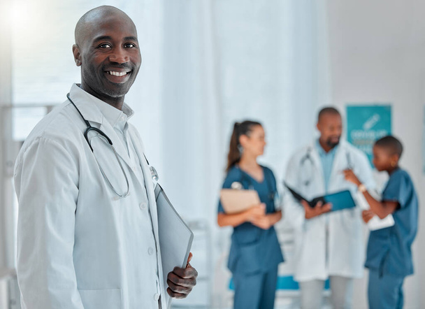 Hospital, doctor and portrait of black man with smile for medical care, wellness and support. Healthcare, clinic teamwork and face of happy male health worker for service, consulting and insurance. - Foto, Bild
