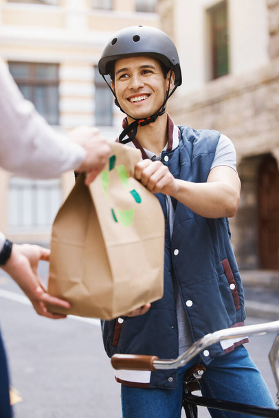 Man, delivery bicycle and smile with bag, order or e commerce for food, product or sustainable transport. Young guy, bike and cbd street for customer experience, chat or eco friendly at logistics job. - Foto, Bild