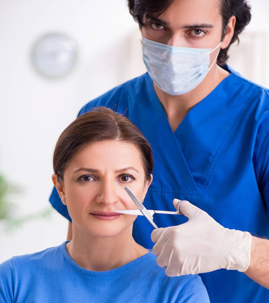 The woman visiting male doctor for plastic surgery - Photo, Image