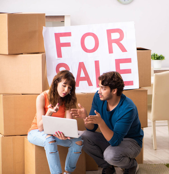 A jovem família oferecendo casa para venda e sair
 - Foto, Imagem