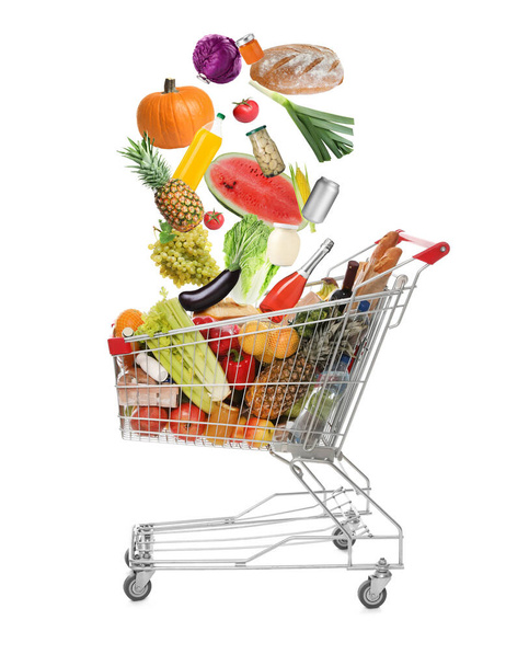 Market assortment. Different products falling into shopping cart on white background - Fotografie, Obrázek