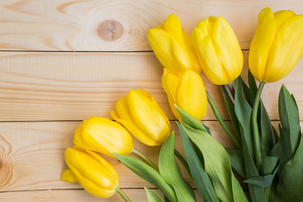 Beautiful yellow tulips on wooden background - Fotoğraf, Görsel
