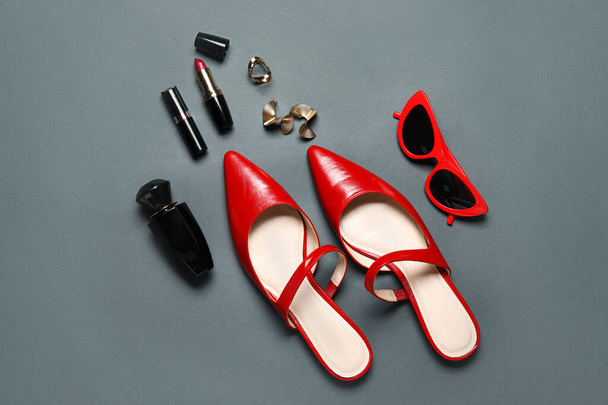 Stylish female shoes, cosmetics and accessories on dark background - Φωτογραφία, εικόνα