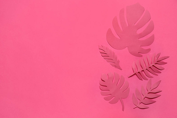 Different paper tropical leaves on pink background - Fotoğraf, Görsel