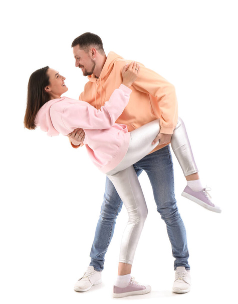 Happy engaged couple dancing on white background - Fotó, kép