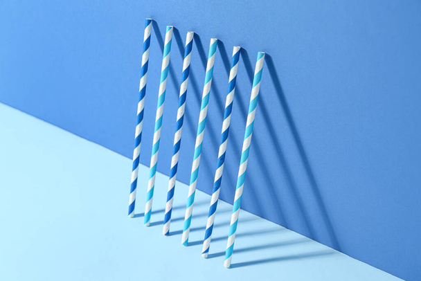 Different paper drinking straws on blue background - Фото, зображення
