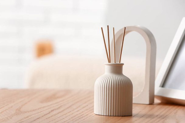 Bottle of reed diffuser on table in room, closeup - Photo, Image