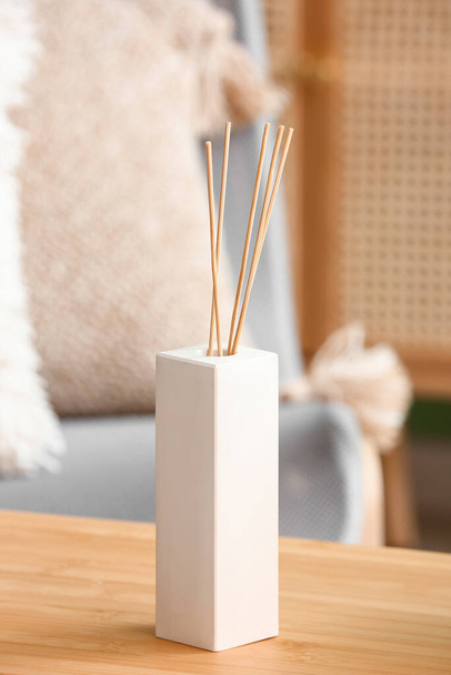 Bottle of reed diffuser on table, closeup - Foto, afbeelding