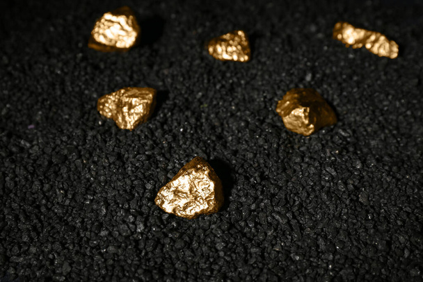 Golden nuggets on black coal - Photo, Image
