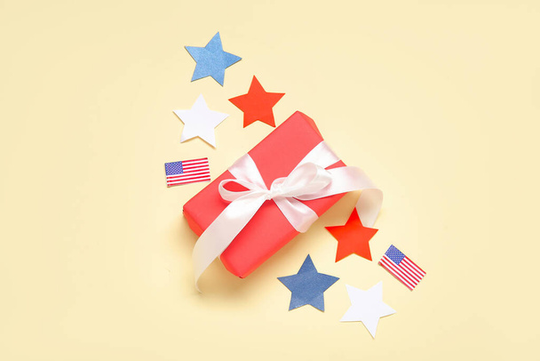 Caixa de presente com bandeiras e estrelas dos EUA em fundo amarelo pálido. Dia da independência americana - Foto, Imagem