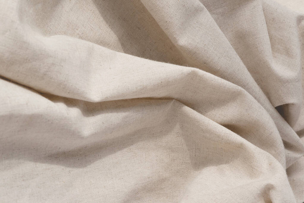 Soft draped neutral beige linen fabric texture, aesthetic textile background with an abstract folds, wedding or brand template, copy space - Foto, Imagen