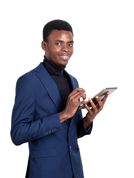 Black businessman working in tablet, happy successful portrait with gadget. Online network and social media, isolated over white background. Concept of digital connection and internet - Photo, image