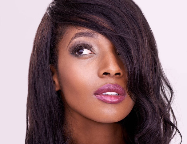 Beauty, thinking and makeup on face of black woman in studio for hair extension, cosmetics or glow. Headshot of african female model on pink background for facial shine, skin care or luxury aesthetic. - Valokuva, kuva