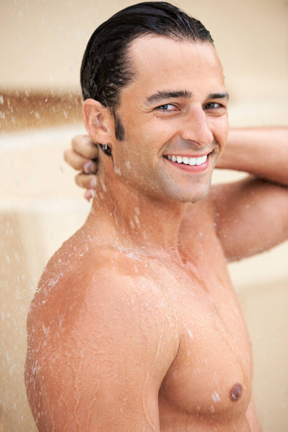Man, shower and water drop with smile, portrait and bathroom for hygiene, self care and morning for skin routine. Young guy, body cleaning and healthy for skincare, wellness or happiness in apartment. - 写真・画像