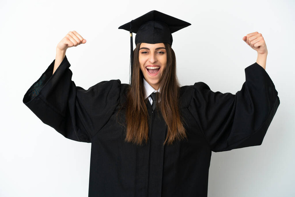 Young university graduate isolated on white background doing strong gesture - Φωτογραφία, εικόνα
