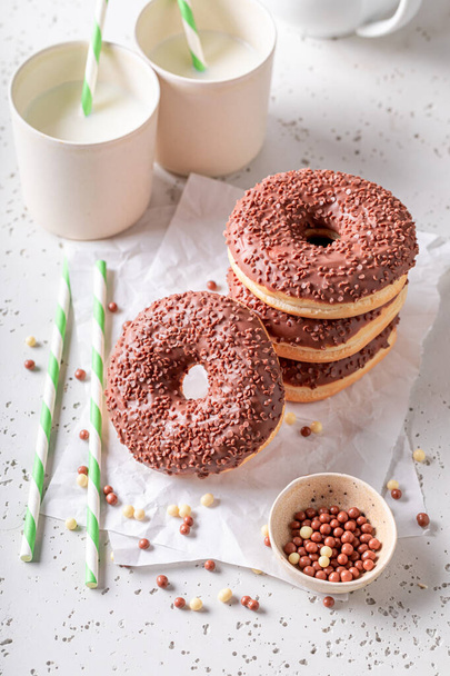 Tasty and fresh donuts as popular snack. Served with milk. Most popular dessert. - Photo, Image