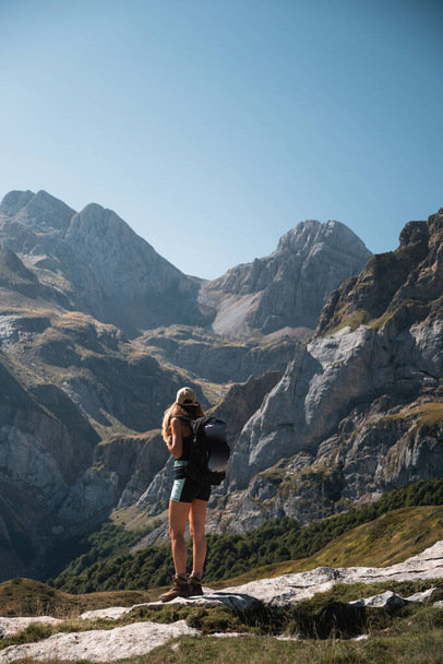mountaineer woman standing looking at the landscape of the pyrenees in summer - Φωτογραφία, εικόνα