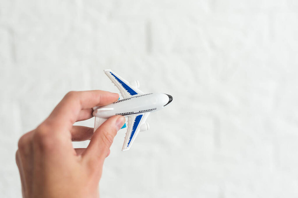 hand holding airplane toy model isolated on white background - 写真・画像
